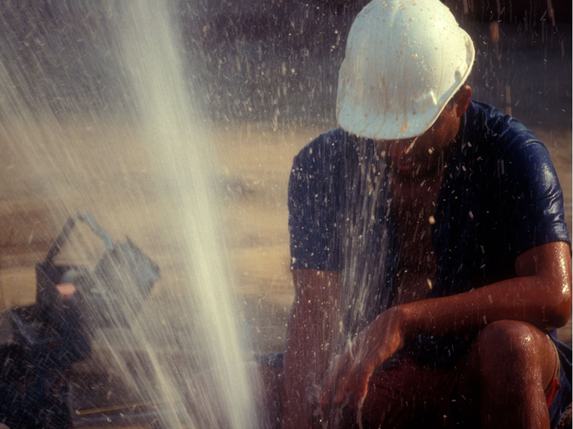 Water spraying from a burst pipe during plumbing repair